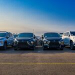 Multiple SUVs parked outdoors under a clear blue sky. Modern and sleek automotive design.